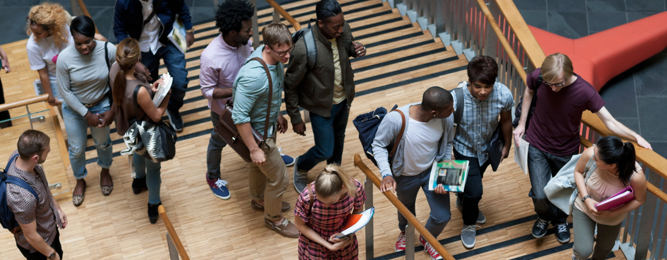 students walking in a university staircase